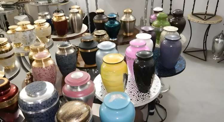 Collection of finished brass adult cremation urns in varied colours and finishes